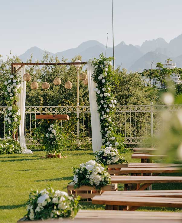 A beautifully decorated outdoor wedding venue surrounded by flowers, protected with Pro Mosquito Solutions mosquito spray for a pest-free celebration.