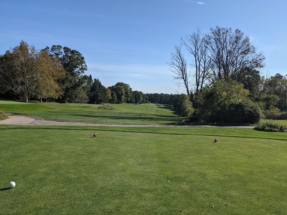 Scenic view of the golf course at West Warwick Country Club with rolling greens and surrounding trees.