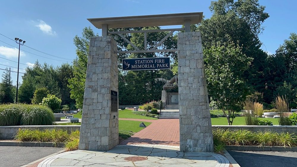 Station Fire Memorial Park in West Warwick, RI, featuring a tranquil memorial area with stone markers and landscaped gardens.