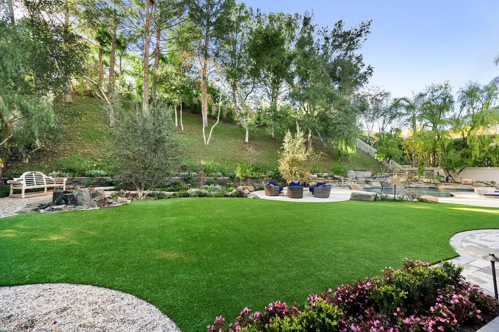 A pest-free yard with a lush green lawn maintained by Pro Mosquito Solutions pest control services in Rhode Island and Southeastern Massachusetts.