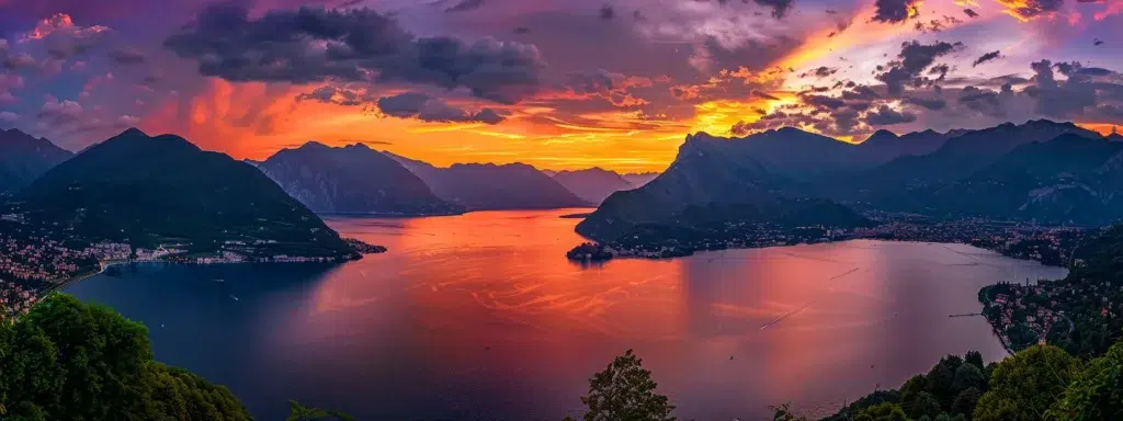 a breathtaking sunset illuminates a tranquil lake, casting vibrant hues of orange and purple across the sky, with silhouetted mountains framing the serene waters.